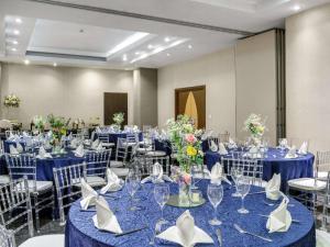 a banquet room with blue tables and chairs at Novotel Panama City in Panama City