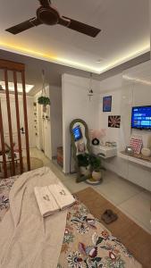 a bedroom with a bed and a desk with a computer at Flippy Escapes in Zirakpur +30 photos