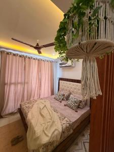 a bedroom with a bed with a hanging plant at Flippy Escapes in Zirakpur
