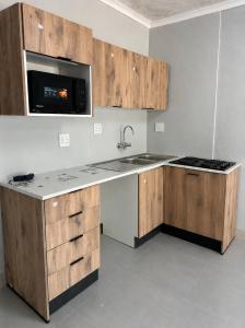 a kitchen with a sink and a microwave at Mine Lux Rentals in Thabazimbi