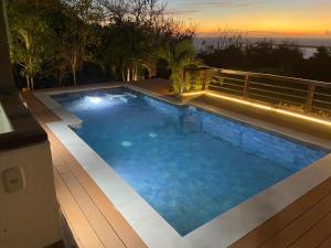 a large swimming pool with a lights on a deck at Casa de Campo con Vista al Mar in Tubará