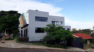 a white building with a mural on the side of it at Studio Central IV in Cascavel