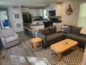 a living room with a couch and chairs and a kitchen at West Battle Lake w Lake Views in Battle Lake
