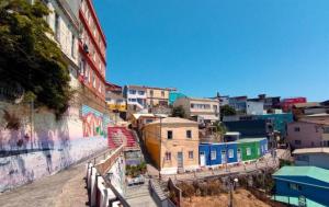 a city with graffiti on the side of a building at Wind & Way Hostel in Valparaíso