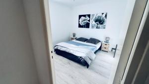 a bedroom with a bed in a white room at Location corsica in Ajaccio