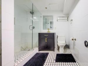 a bathroom with a toilet and a glass shower at Hotel Harrison On the Beach in Miami Beach +53 photos