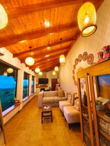 a living room with a couch and a table at Laguna de Cuicocha Guest House in Urcusiqui +25 photos