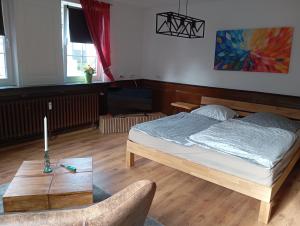 a bedroom with a bed and a table at Zwischen Acker und Herz Hartmannshof in Algermissen