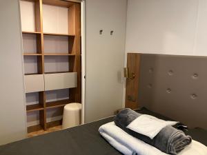 a small room with a bed and a closet at Grand mobile-home 45M2 au calme et au bord de mer in Saint-Brevin-les-Pins +20 photos