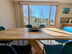 a conference room with a large wooden table and chairs at Argentine 1516 by SummitCove Lodging in Colorado in Keystone