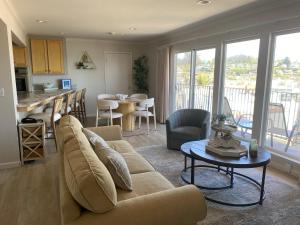 a living room with a couch and a table at Capitola Beach Suites in Capitola