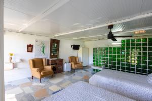a living room with two chairs and green tiles at Jacaranda in Cádiz
