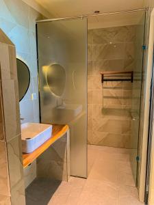 a bathroom with a shower and a sink at Chill Beach House in Phú Quốc +37 photos