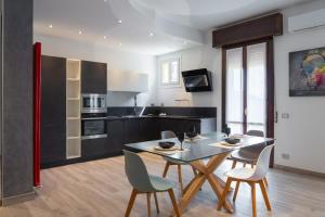 a kitchen with a table and chairs in a room at Emilia Suite Space in Modena +11 photos