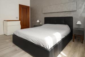 a bedroom with a large bed and two night stands at Emilia Suite Space in Modena