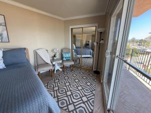 a bedroom with a bed and a balcony at Capitola Beach Suites in Capitola