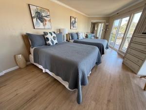a bedroom with two beds and a window at Capitola Beach Suites in Capitola