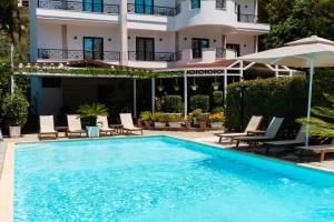 a large swimming pool in front of a building at JB Hotel in Sarandë