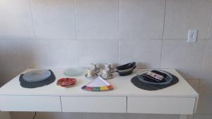 a white counter with hats and plates on it at Hostel OS ETERNOS MONIS in Rio de Janeiro +11 photos
