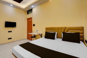 a hotel room with a bed and a tv at Hotel O Utsav In in Jabalpur