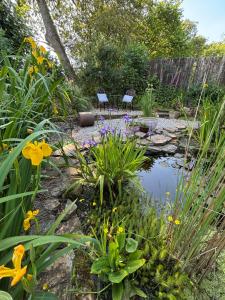 a garden with a pond and some flowers at Trelawney in Yelverton