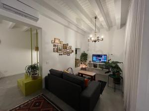 a living room with a couch and a tv at La Casa di Mariano in Terrasini