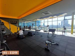 a man sitting in a gym with a view of an airport at Cozy Stay Studio in Shah Alam