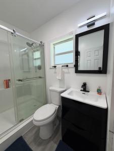 a bathroom with a toilet and a sink and a shower at Water front Lake House in Okeechobee +5 photos
