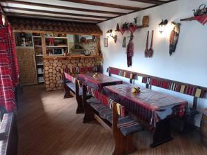 a restaurant with two tables and a counter in a room at Deny Holiday home in Dobrinishte