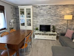 a living room with a table and a television at Las tres Luces Casa 2 in Picones