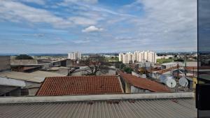 a view of a city with tall buildings and roofs at Pousada Sevilha in Sumaré