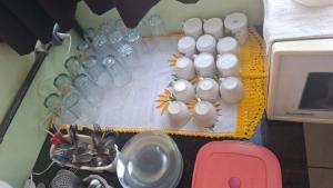 a group of glasses and other items on a table at Pousada Sevilha in Sumaré