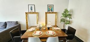 a dining room table and chairs with a table and mirrors at Central Luxembourg Stay-2BR in Hollerich +7 photos