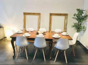 a dining room with a wooden table and chairs at Central Luxembourg Stay-2BR in Hollerich