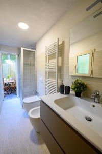 a bathroom with a sink and a toilet and a tub at Dimora l'Arancio in Lucca +7 photos