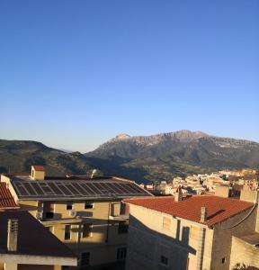 a view of a city with mountains in the background at Domo Mea in Orgosolo