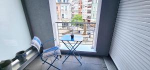 a balcony with a table and two chairs on a balcony at Central Luxembourg Stay-2BR in Hollerich
