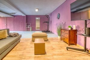 a living room with purple walls and a couch at 4BR Wellness Villa- Pool, Sauna, Gym in Puerto de la Cruz