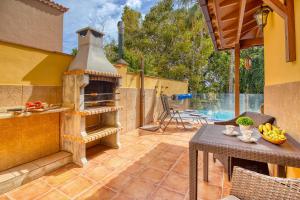 an outdoor kitchen with a pizza oven on a patio at 4BR Wellness Villa- Pool, Sauna, Gym in Puerto de la Cruz