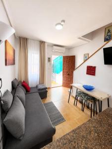 a living room with a couch and a table at Casita de Lucia in Santa Pola +15 photos