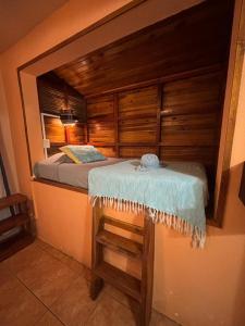 a small bedroom with a bed in a room at Tico Adventure Lodge in Sámara
