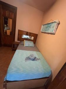 a small room with a bed with a towel on it at Tico Adventure Lodge in Sámara +150 photos
