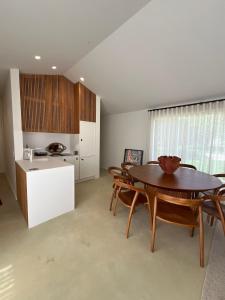a kitchen and dining room with a table and chairs at Dovecote Houses in Viana do Castelo