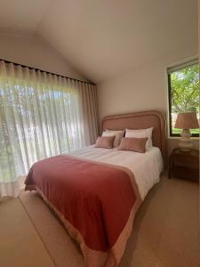 a bedroom with a large bed and a window at Dovecote Houses in Viana do Castelo +54 photos