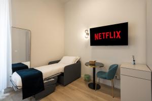 a hospital room with a bed and a netflix sign on the wall at Aethel Guesthouse in Rome +20 photos