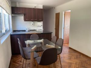 a kitchen and dining room with a glass table and chairs at Hostal Recreo in Viña del Mar