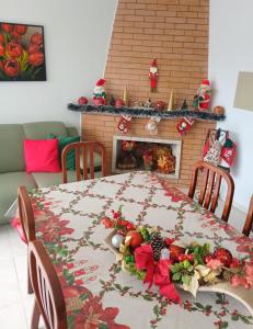 a dining room table with christmas decorations on it at Pousada Fernanda in Guarapuava +3 photos