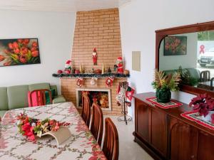 a dining room with a table and a fireplace at Pousada Fernanda in Guarapuava