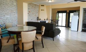 a living room with a table and a couch at One Bedroom Villa in Alikanas +39 photos