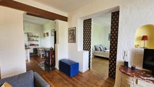 a living room with a couch and a dining room at Helle Ferienwohnung - Südeifel bei Neuerburg in Ammeldingen